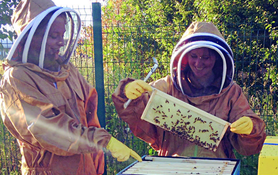 Rosamund Portus (right) beekeeping with a friend.