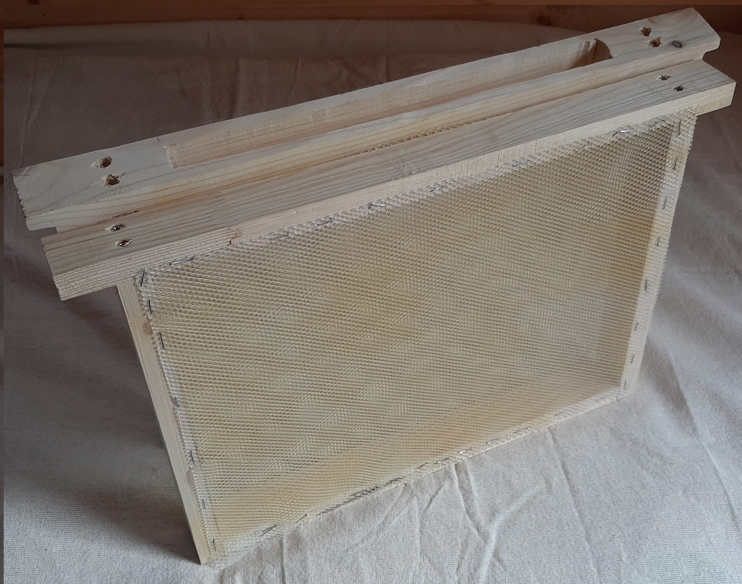 Figure 1. Collectors for collecting propolis: A – 3D-collector model in the form of a hive frame in sections; B – manufactured 
collectors of different types that were used 
in the study; C – a collector during the 
inspection of the experimental bee family 
with partial deposition of propolis