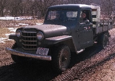 Huber Wheeler and his 1952 Jeep that Clyde used and his son Huber used for beekeeping. Gregg Wheeler is now using it. The truck was handed down through the generations.