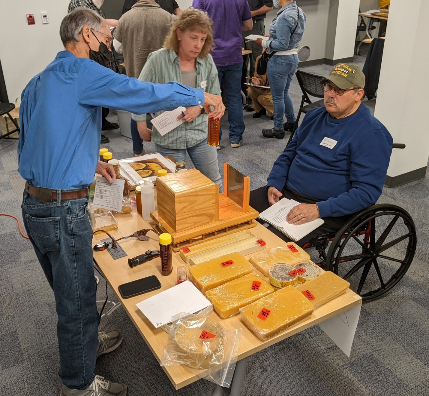 Certified Maryland Judge, Bart Smith demonstrates using a polariscope to detect 
crystals in extracted honey. Photo By: Allen Hayes