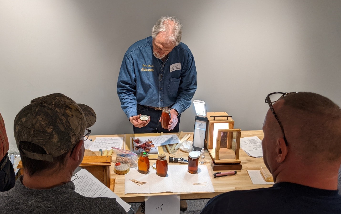 Certified Maryland Judge, David Morris explains that the underside of the honey jar lid must be clean and free of debris. Photo By: Allen Hayes