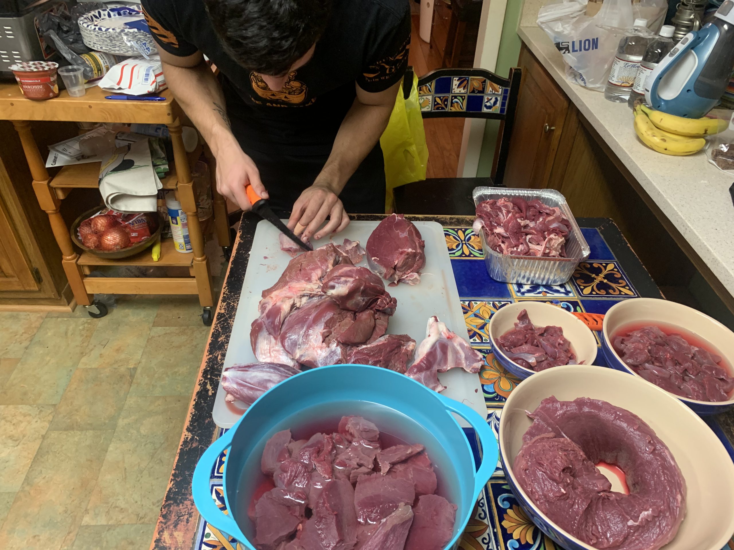 Henry cutting up deer meat.