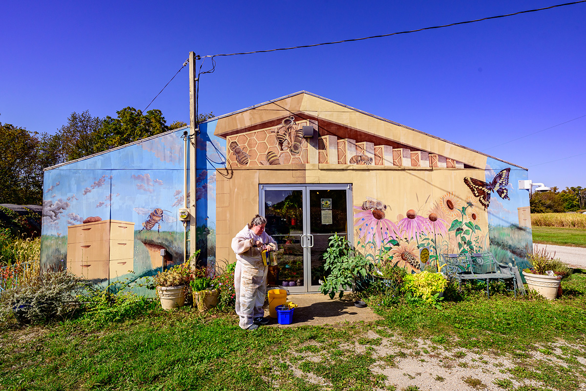 Program manager Lesley Deem prepares a smoker outside the Pollinatarium in Urbana, Illinois. The facility, the first of its kind in the nation, is designed to heighten awareness of the ecological partnerships between pollinators and the plants that depend on them. Photo by Fred Zwicky