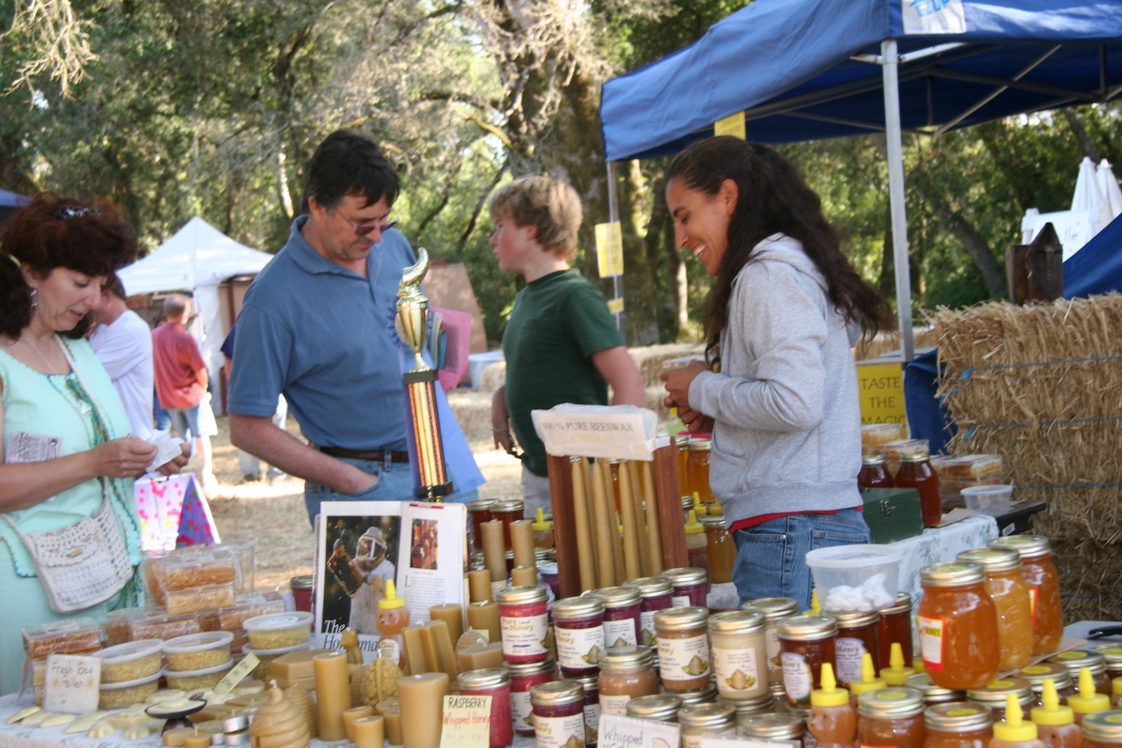 Hector’s wife Sandra Alvarez selling candles, pollen and honey at the Gravenstein Apple Fair. Photo by Ettamarie Peterson