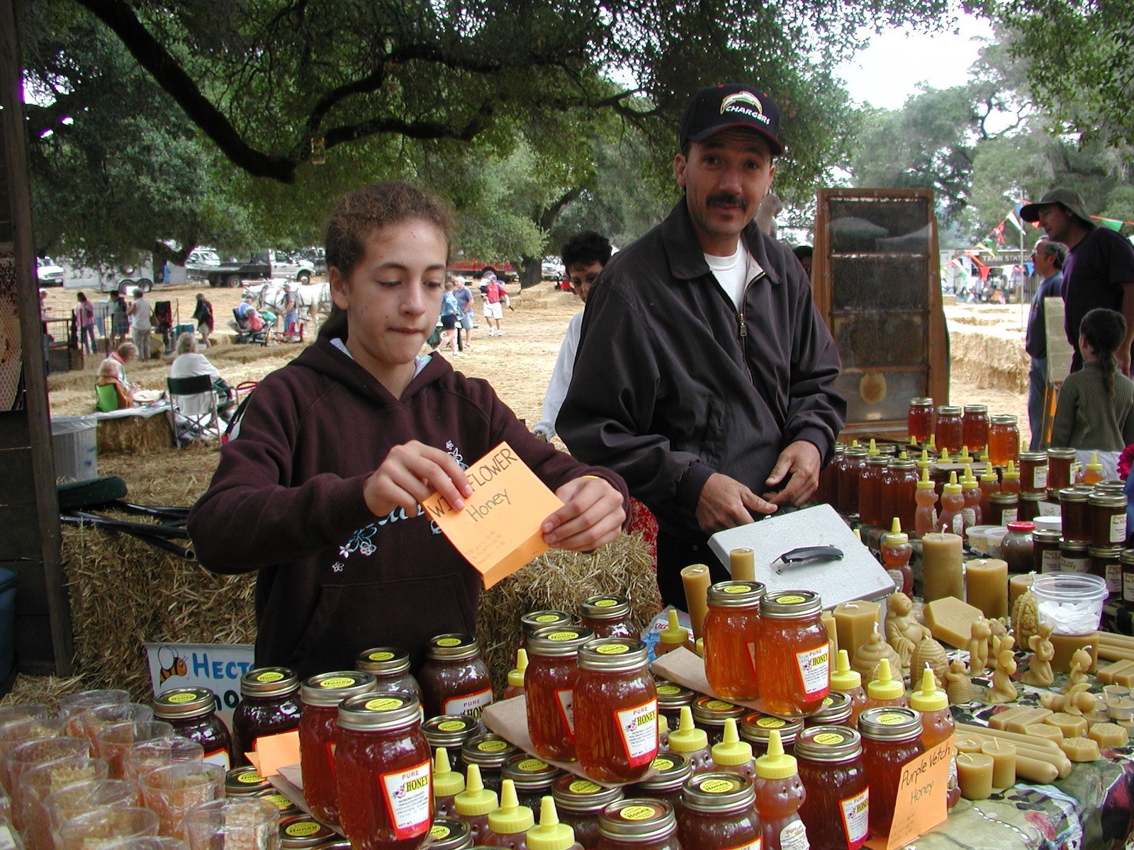 Hector’s daughter Cynthia Alvarez helping Hector at the Gravenstein Apple Fair. Photo by Ettamarie Peterson